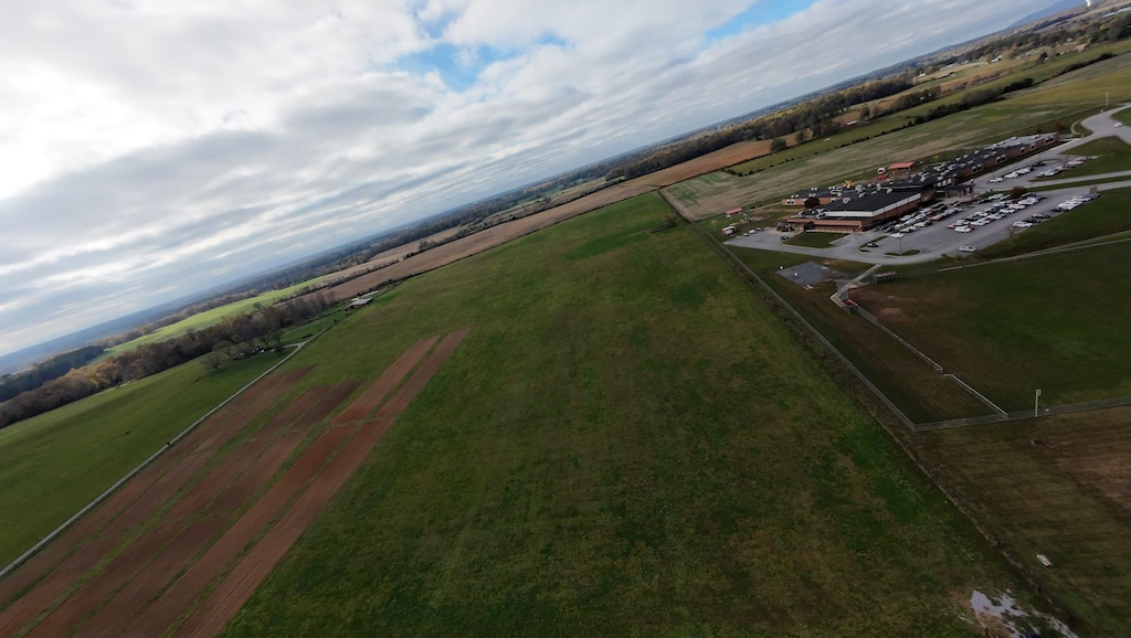 birds eye view of property with a rural view