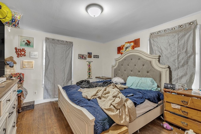 bedroom with dark hardwood / wood-style floors