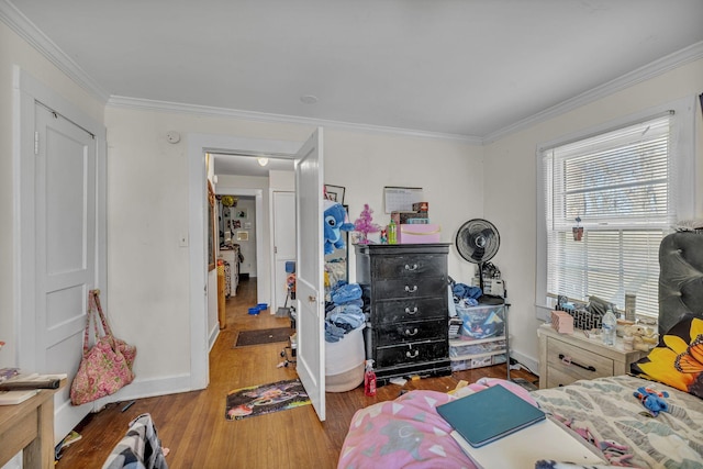 bedroom featuring ornamental molding and hardwood / wood-style flooring