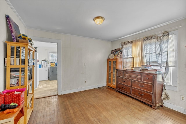 interior space featuring light hardwood / wood-style floors and crown molding