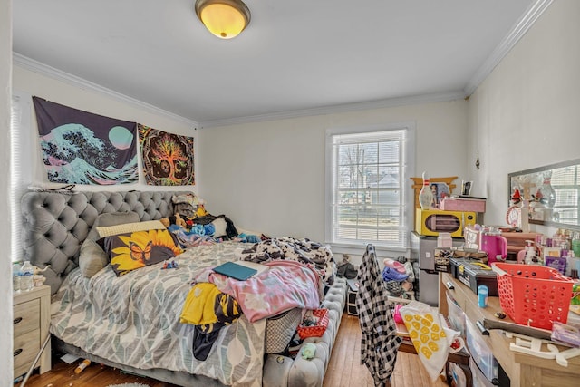 bedroom with ornamental molding and wood-type flooring