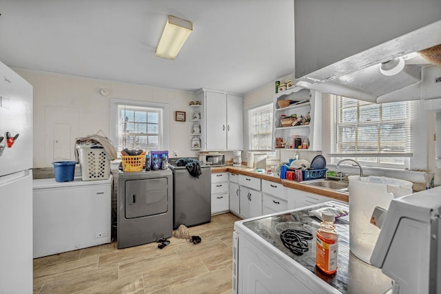 kitchen with white appliances, white cabinets, ventilation hood, and sink