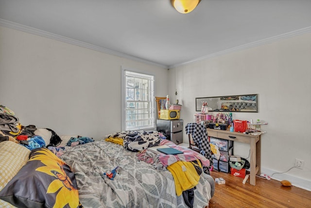 bedroom with wood-type flooring and crown molding