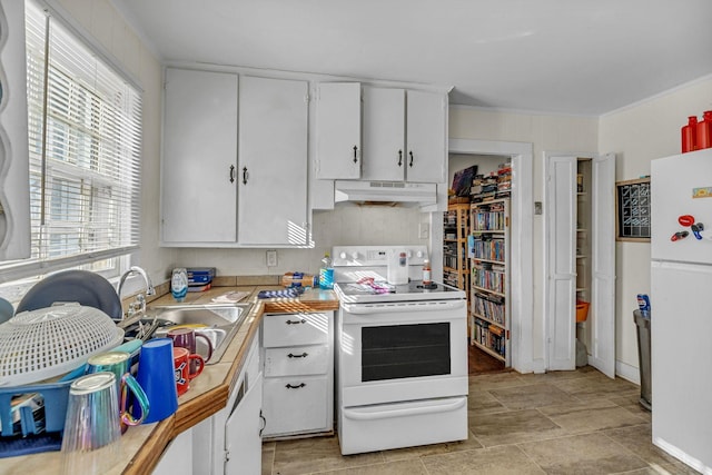 kitchen featuring white appliances, a healthy amount of sunlight, white cabinets, and sink