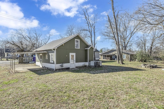 view of property exterior featuring central AC unit and a lawn