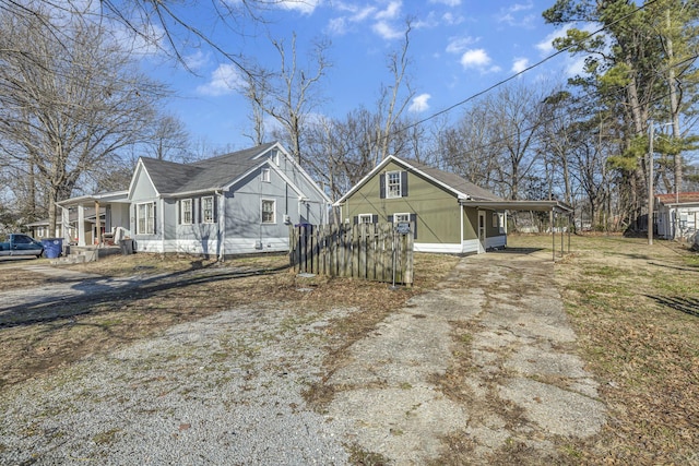 view of side of home with a carport and covered porch