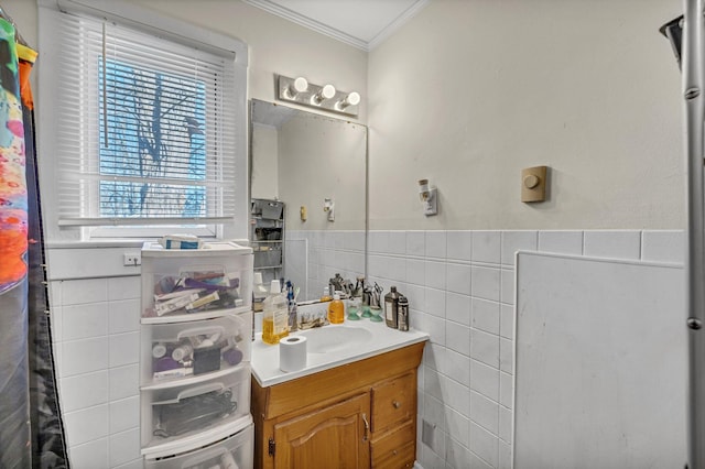 bathroom featuring tile walls, ornamental molding, a healthy amount of sunlight, and vanity