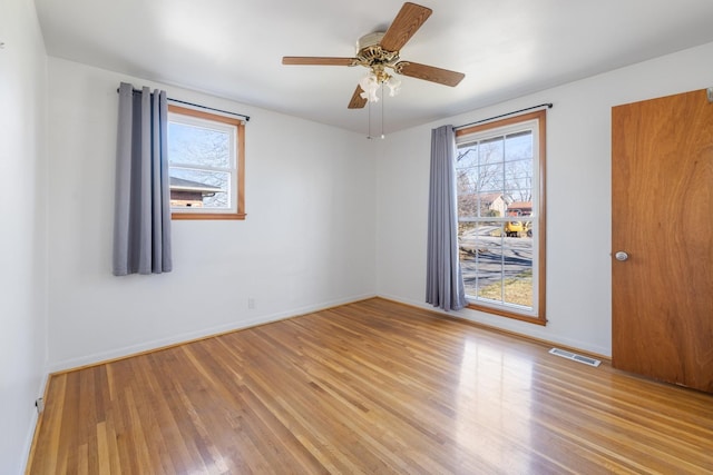 spare room with light wood-type flooring and ceiling fan