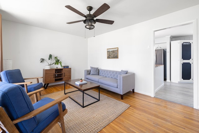 living room featuring ceiling fan and light hardwood / wood-style floors