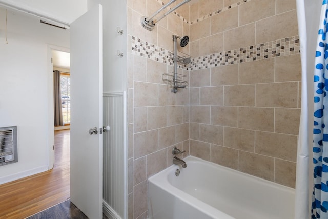 bathroom featuring wood-type flooring, shower / bath combo, and heating unit