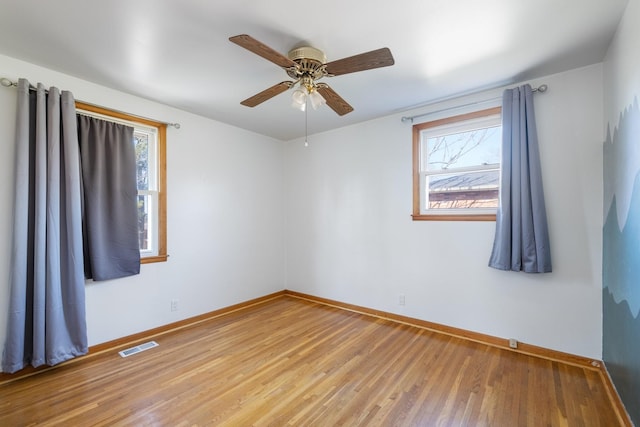 empty room with wood-type flooring and ceiling fan