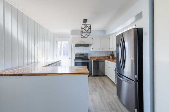 kitchen with stainless steel appliances, white cabinets, light wood-type flooring, kitchen peninsula, and wood counters