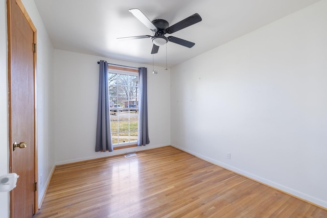 empty room with light hardwood / wood-style floors and ceiling fan