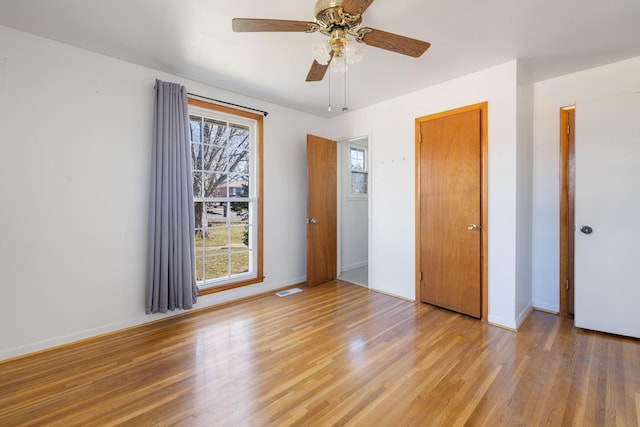 unfurnished bedroom with ceiling fan and light hardwood / wood-style floors