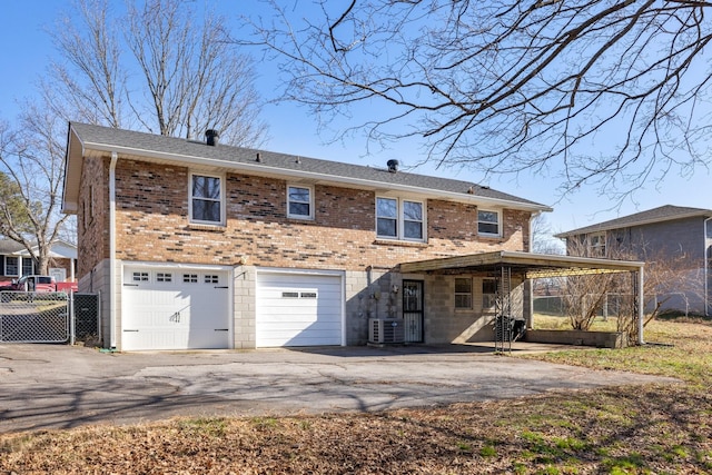 rear view of house featuring a garage, central AC, and a carport