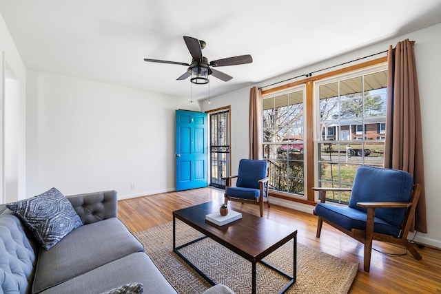 living room featuring ceiling fan, a wealth of natural light, and hardwood / wood-style flooring