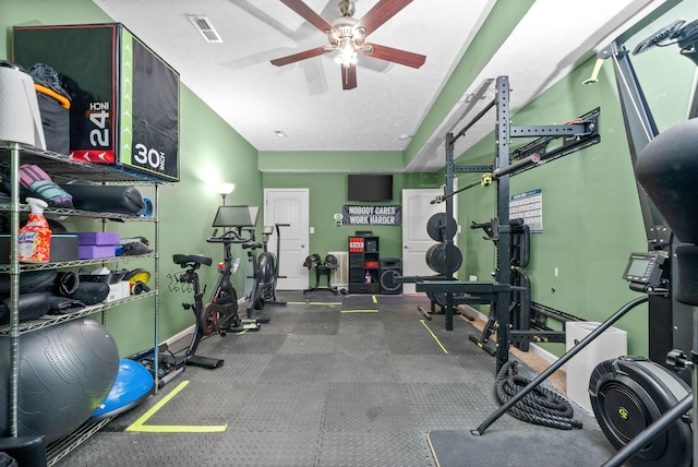 gym with a textured ceiling and ceiling fan