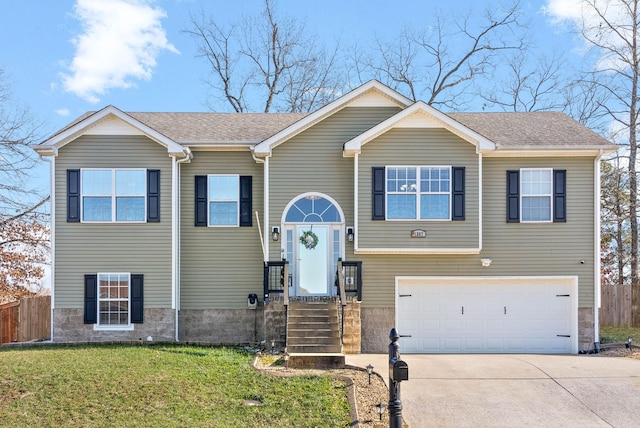 bi-level home with a front lawn and a garage