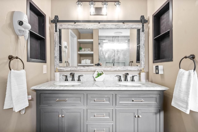 bathroom with a shower with door and vanity