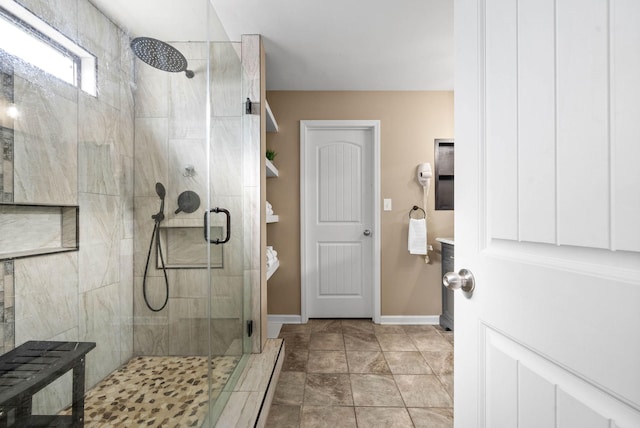 bathroom with a shower with door