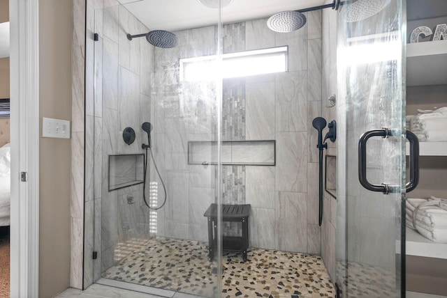 bathroom featuring a shower with door