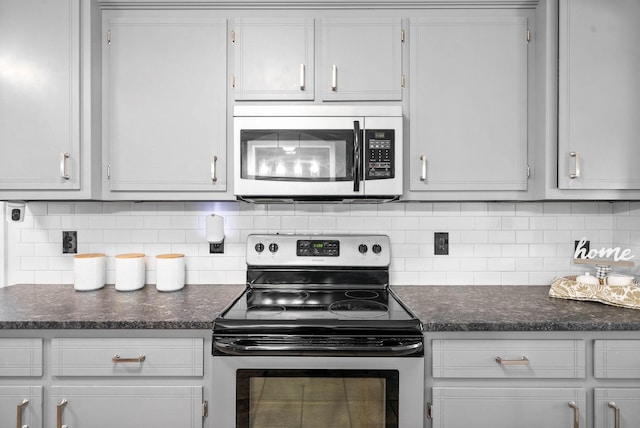 kitchen featuring stainless steel appliances, white cabinets, and tasteful backsplash