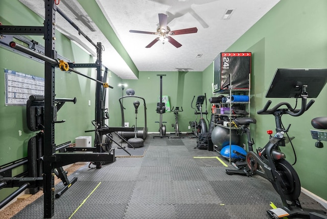 gym with a textured ceiling and ceiling fan