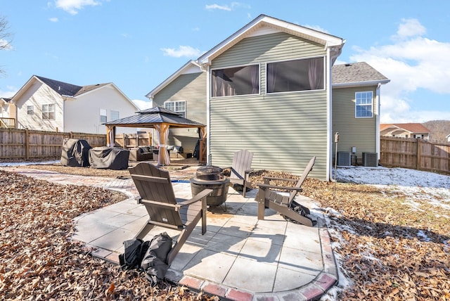 rear view of house with a gazebo, a fire pit, and a patio area