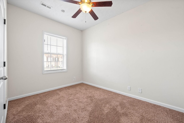 carpeted spare room with ceiling fan