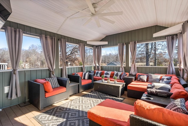 sunroom / solarium featuring ceiling fan, wood ceiling, vaulted ceiling, and plenty of natural light