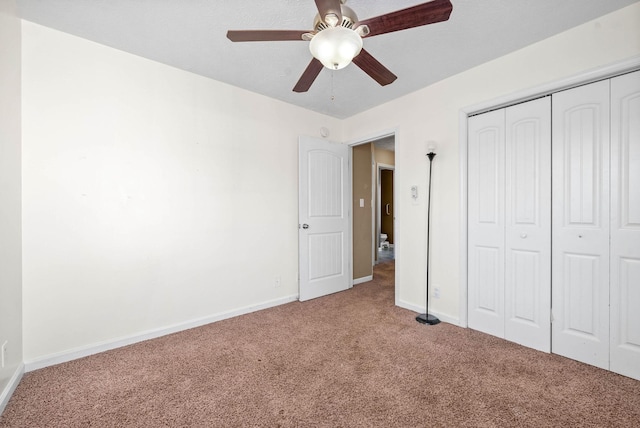 unfurnished bedroom with ceiling fan, a closet, and carpet floors