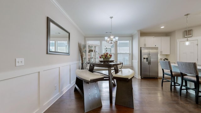 dining space with dark hardwood / wood-style flooring, ornamental molding, and a notable chandelier