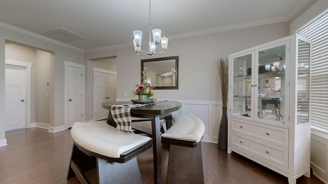 dining room with an inviting chandelier, dark hardwood / wood-style floors, and crown molding