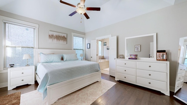 bedroom featuring ceiling fan, connected bathroom, dark hardwood / wood-style flooring, and lofted ceiling