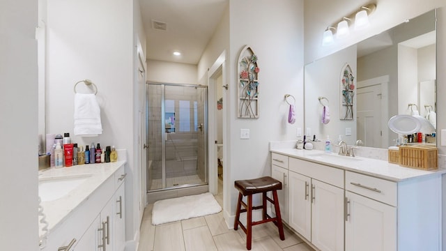 bathroom featuring an enclosed shower and vanity