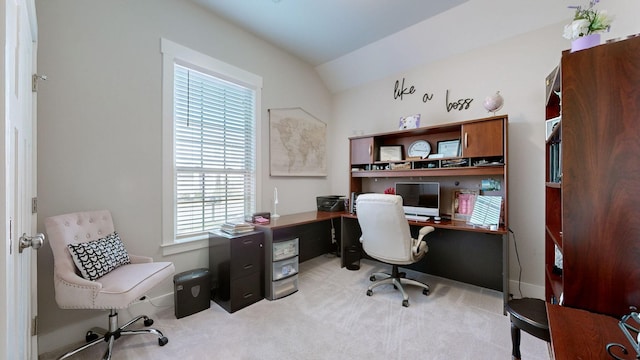 office area featuring light carpet and vaulted ceiling