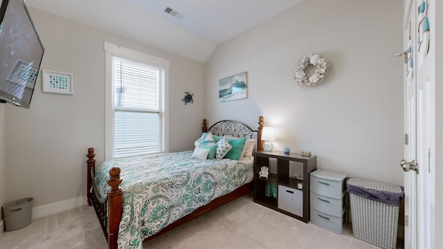 bedroom featuring light carpet and lofted ceiling