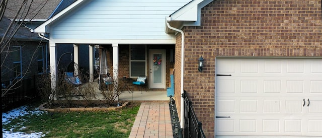 entrance to property featuring a garage and a porch