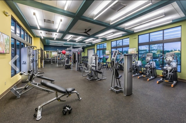 exercise room featuring ceiling fan and coffered ceiling