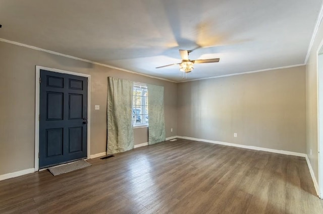 interior space with crown molding, baseboards, and wood finished floors