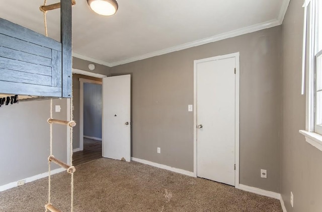 unfurnished bedroom with carpet flooring, crown molding, and baseboards