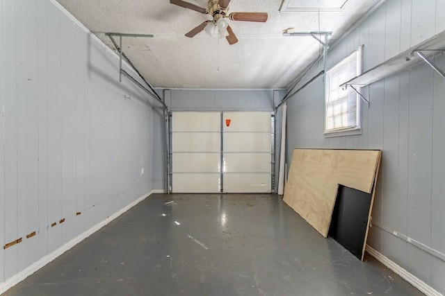 garage with ceiling fan and baseboards