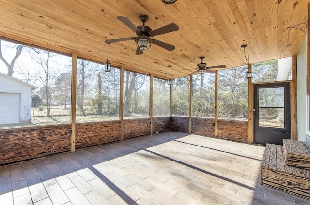 unfurnished sunroom featuring wooden ceiling and a ceiling fan