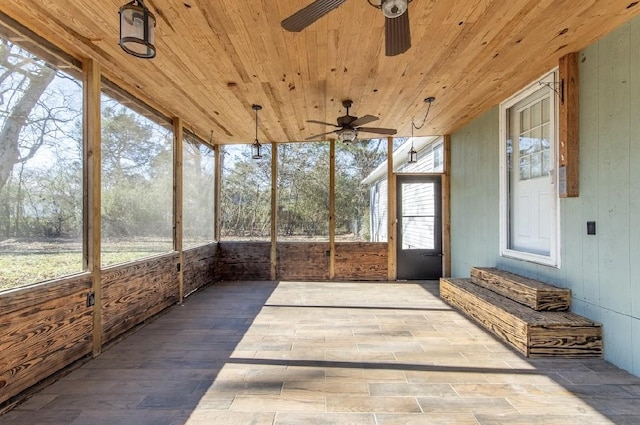 sunroom / solarium with ceiling fan and wood ceiling