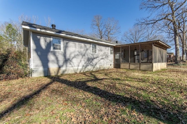 back of property with a yard and a sunroom