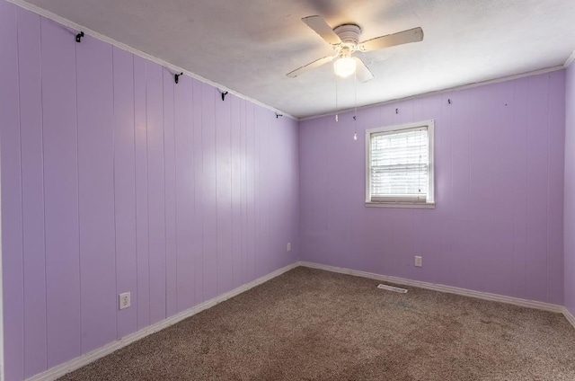 unfurnished room with carpet floors, visible vents, and a ceiling fan