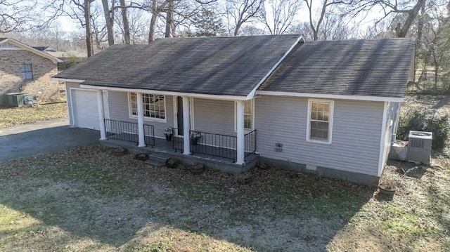 view of front of property with aphalt driveway, a shingled roof, a porch, and cooling unit