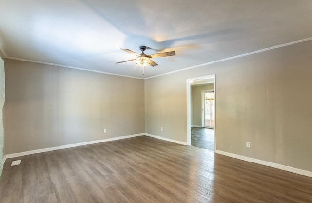 unfurnished room featuring baseboards, ceiling fan, wood finished floors, and crown molding