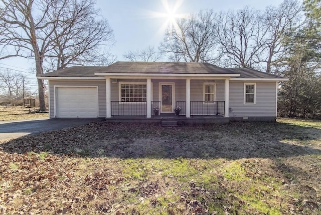 single story home with a garage, covered porch, and aphalt driveway