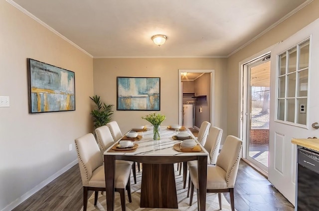 dining room with dark wood-type flooring, crown molding, and baseboards